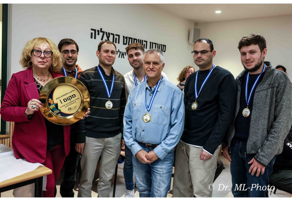בתמונה: שחקני קבוצת מועדון השחמט באר שבע - אלופי המדינה לשנת 2024, ראשת הקבוצה ומנהלת מועדון השחמט גב' אילנה דוד ושחקני הקבוצה עם צלחת האליפות משנה שעברה. קרדיט ד"ר מרק ליבשיץ